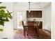 Dining area features a dark wooden table and cabinetry with access to another dining space beyond at 320 Kirk Rd, Decatur, GA 30030