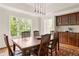 Bright dining room with large windows and a dark wood table, flowing into the kitchen area at 320 Kirk Rd, Decatur, GA 30030