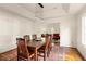 Open dining room leading into the living room with dark hardwood floors and tray ceiling at 320 Kirk Rd, Decatur, GA 30030