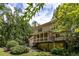 Back of house features a screened in porch, deck, second story windows, and lush landscaping at 320 Kirk Rd, Decatur, GA 30030
