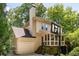 Back of house features a screened in porch, deck, and basketball hoop above the driveway at 320 Kirk Rd, Decatur, GA 30030