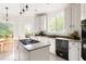 Open kitchen featuring white cabinets, granite countertops, a center island, and backyard views at 320 Kirk Rd, Decatur, GA 30030
