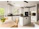 Bright kitchen boasts white cabinets, granite countertops, and a center island with a gas stovetop at 320 Kirk Rd, Decatur, GA 30030