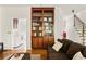 The living room features hardwood floors, a bookshelf, and provides access to both a laundry room and staircase at 320 Kirk Rd, Decatur, GA 30030