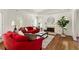Bright living room with tray ceilings, hardwood floors, a fireplace, and red sofas at 320 Kirk Rd, Decatur, GA 30030