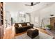 Comfortable living room features hardwood floors, a fireplace, a ceiling fan and access to the kitchen at 320 Kirk Rd, Decatur, GA 30030