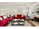 Inviting living room with fireplace, hardwood floors, and ample natural light from shuttered windows at 320 Kirk Rd, Decatur, GA 30030