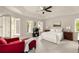 Bright main bedroom with a ceiling fan, shuttered windows, and seating area at 320 Kirk Rd, Decatur, GA 30030