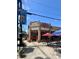 Exterior shot of Mojo Pizza Pub, highlighting the storefront, signage, and outdoor seating at 320 Kirk Rd, Decatur, GA 30030