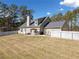Spacious backyard boasting a manicured lawn, a privacy fence, and a covered patio area for entertaining at 8007 Wishaw Ct, Winston, GA 30187