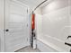 Clean white bathroom with a shower/tub combo and crisp white walls at 8007 Wishaw Ct, Winston, GA 30187