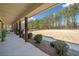 Inviting covered porch with lush landscaping and plenty of space for outdoor seating at 8007 Wishaw Ct, Winston, GA 30187