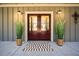 Inviting front entrance with double doors, decorative plants, and stylish lighting fixtures at 8007 Wishaw Ct, Winston, GA 30187