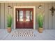 Inviting front entrance with double doors, decorative plants, and stylish lighting fixtures at 8007 Wishaw Ct, Winston, GA 30187