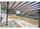 Outdoor patio area featuring a pergola covering with string lights overlooking a spacious backyard with a playset at 8007 Wishaw Ct, Winston, GA 30187