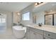 Bright bathroom with double sinks, bathtub, and ample counter space at 178 Haverling Pass, Hampton, GA 30228