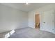 Cozy bedroom with neutral carpeting and adjoining bathroom at 178 Haverling Pass, Hampton, GA 30228