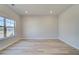 A sun-filled bedroom boasts wood-look floors and neutral paint at 178 Haverling Pass, Hampton, GA 30228