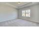 Bright, airy bedroom featuring a large window and tray ceiling at 178 Haverling Pass, Hampton, GA 30228