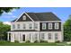 Charming two-story home featuring a light brick exterior and welcoming front porch at 178 Haverling Pass, Hampton, GA 30228