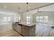 Island with a sink overlooks the living area in this open-concept home with vaulted ceilings and many windows at 178 Haverling Pass, Hampton, GA 30228