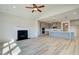 Open-concept living space with fireplace that flows into a modern kitchen with island seating at 178 Haverling Pass, Hampton, GA 30228