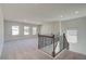Spacious loft area with carpeted floors and windows at 178 Haverling Pass, Hampton, GA 30228