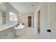 Luxurious bathroom with a soaking tub, double vanity, and walk-in shower at 178 Haverling Pass, Hampton, GA 30228