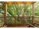 Relaxing screened balcony with overhead string lights and views of lush trees at 2230 Peachtree Ne Rd # A-3, Atlanta, GA 30309