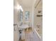 Bathroom featuring tiled shower and floors, pedestal sink, medicine cabinet, and lighting at 2230 Peachtree Ne Rd # A-3, Atlanta, GA 30309