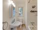 Bathroom with pedestal sink, tiled shower and floors, and a window for natural light at 2230 Peachtree Ne Rd # A-3, Atlanta, GA 30309