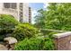 Beautifully landscaped courtyard with lush greenery, a statue, and brick accents at 2230 Peachtree Ne Rd # A-3, Atlanta, GA 30309