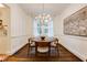 Bright dining room features a round wooden table, modern lighting fixture and large window providing natural light at 2230 Peachtree Ne Rd # A-3, Atlanta, GA 30309