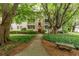 Inviting exterior of a multi-Gathering home with a red door, beautiful trees, and a landscaped walkway at 2230 Peachtree Ne Rd # A-3, Atlanta, GA 30309