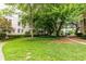 A building's front lawn with mature trees and a walkway through the green grass at 2230 Peachtree Ne Rd # A-3, Atlanta, GA 30309