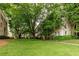 Green lawn surrounded by mature trees in front of an apartment building at 2230 Peachtree Ne Rd # A-3, Atlanta, GA 30309