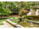 A serene community garden features a stone fountain, benches, and lush landscaping at 2230 Peachtree Ne Rd # A-3, Atlanta, GA 30309
