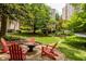 Serene outdoor area with seating around a fire pit, with the community gardens in the background at 2230 Peachtree Ne Rd # A-3, Atlanta, GA 30309