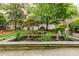 A serene community garden features a stone fountain, benches, and lush landscaping at 2230 Peachtree Ne Rd # A-3, Atlanta, GA 30309