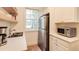 Efficient kitchen features stainless steel appliances, floating shelves, and a view of the exterior at 2230 Peachtree Ne Rd # A-3, Atlanta, GA 30309