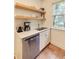 Kitchen featuring stainless steel appliances, floating shelves, neutral countertops and white cabinets at 2230 Peachtree Ne Rd # A-3, Atlanta, GA 30309