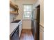 Efficient kitchen with stainless steel appliances, floating shelves, and a view of the exterior at 2230 Peachtree Ne Rd # A-3, Atlanta, GA 30309