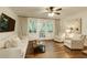 Cozy living room featuring hardwood floors, a white sofa, and access to the screened balcony at 2230 Peachtree Ne Rd # A-3, Atlanta, GA 30309