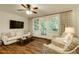 Comfortable living room with hardwood floors, a ceiling fan, and access to the screened balcony at 2230 Peachtree Ne Rd # A-3, Atlanta, GA 30309