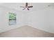 A bright bedroom with a ceiling fan, a window with blinds, and plush carpeting at 3805 Alden Pl, Cumming, GA 30028