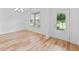 Elegant dining room with hardwood floors, wainscoting and a view of the front yard at 3805 Alden Pl, Cumming, GA 30028
