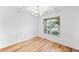 Elegant dining room with coffered ceilings, hardwood floors, wainscoting, and a modern chandelier at 3805 Alden Pl, Cumming, GA 30028