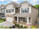Charming two-story home featuring stone accents, gray shutters, and a covered front porch at 3805 Alden Pl, Cumming, GA 30028