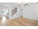Light-filled foyer with wood-look floors and staircase with metal railing leading to the upper level at 3805 Alden Pl, Cumming, GA 30028
