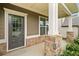 Inviting front porch with stone columns and a gray front door, a perfect entry to the home at 3805 Alden Pl, Cumming, GA 30028